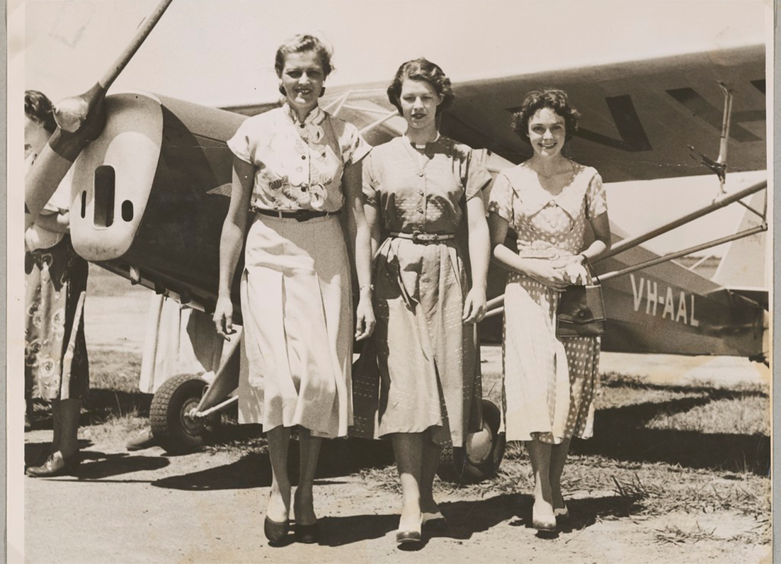 Women in the 1950 standing in front of a airplane